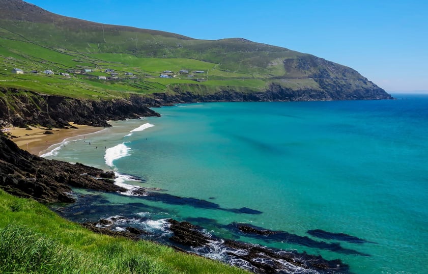 An image of houses perched in green fields overlooking Coumeenole Beach, Dunmore Head, Co. Kerry